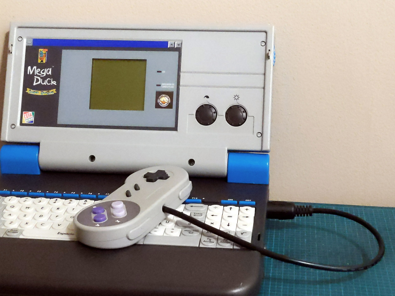 Converted SNES gamepad plugged into a MegaDuck QuiQue laptop